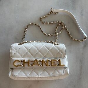 Chanel flap bag featuring the signature diamond-quilted leather, gold-tone chain